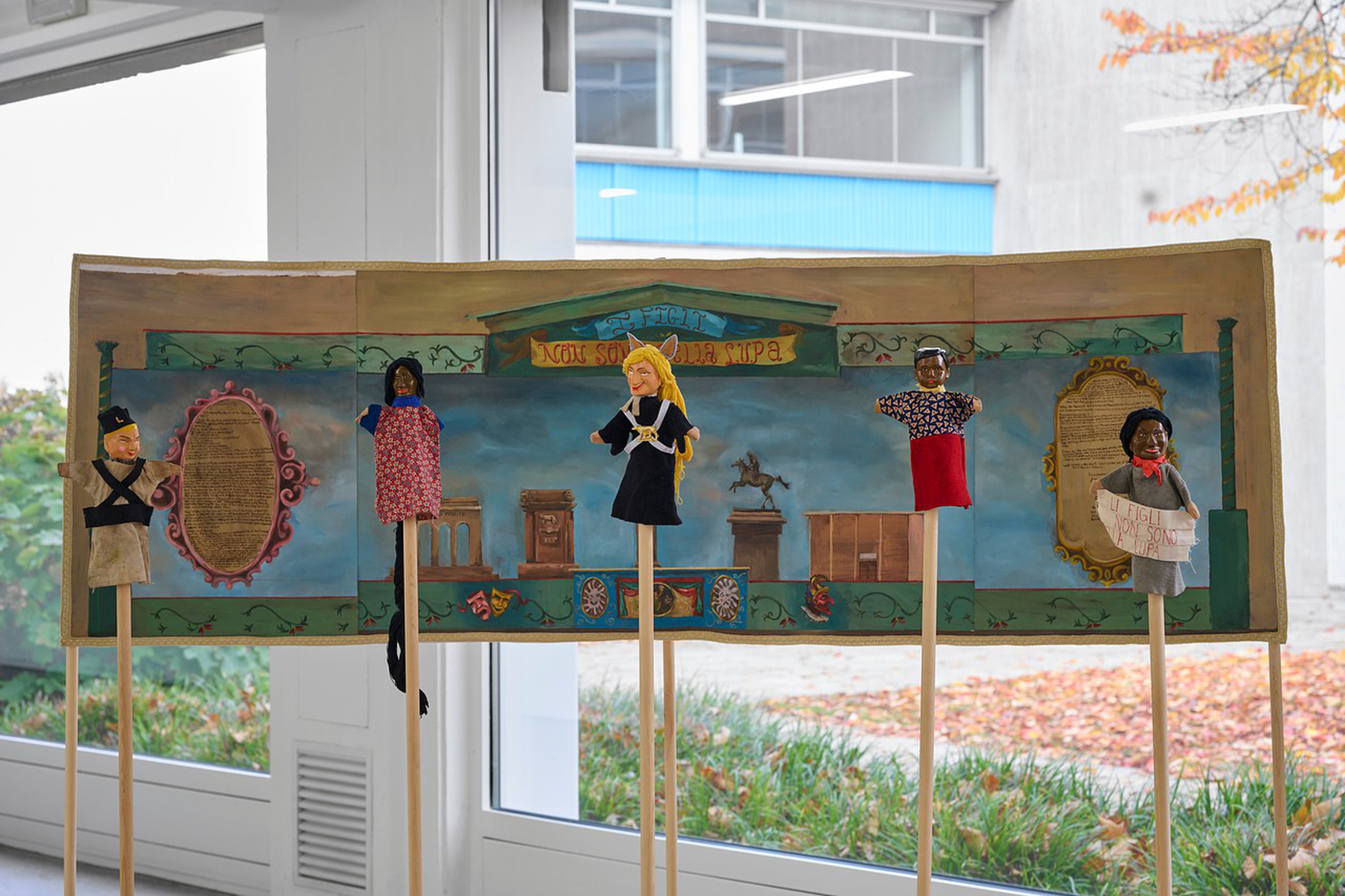 Daniela Ortiz The children are not of the Wolf, 2021 /installation with one painting 73 x 232 cm, five puppets wood hand-carved, sewn, knitted and embroidered costumes and audio 13’47”