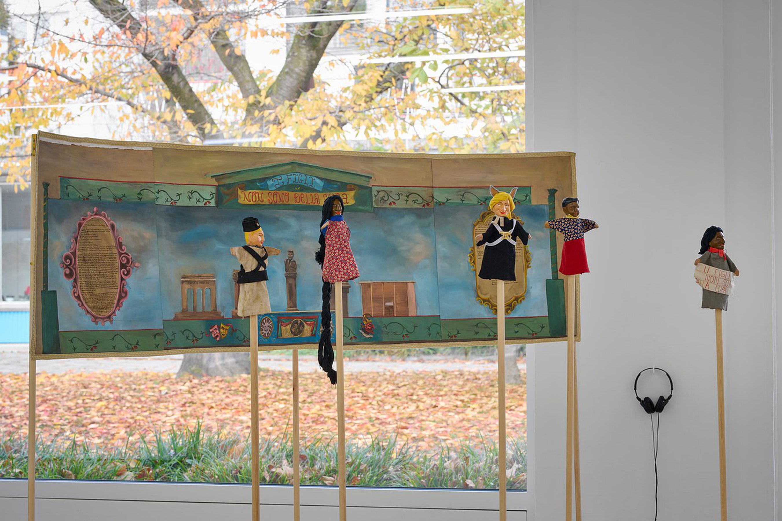 Daniela Ortiz The children are not of the Wolf, 2021 /installation with one painting 73 x 232 cm, five puppets wood hand-carved, sewn, knitted and embroidered costumes and audio 13’47”